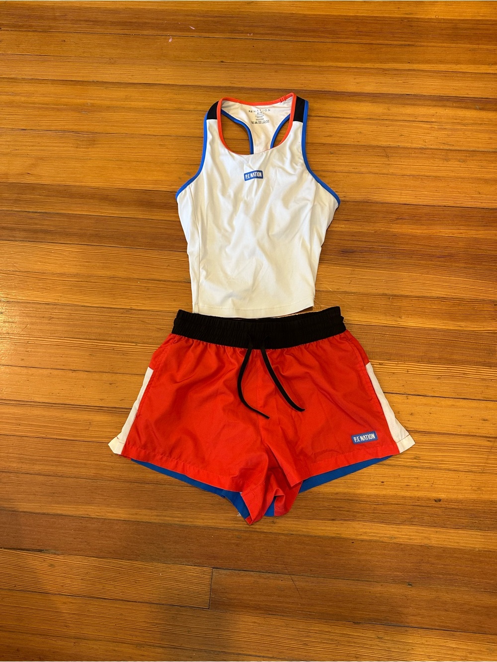 P.E Nation Red Athletic tank & Shorts with Black Waistband and White Side Panels